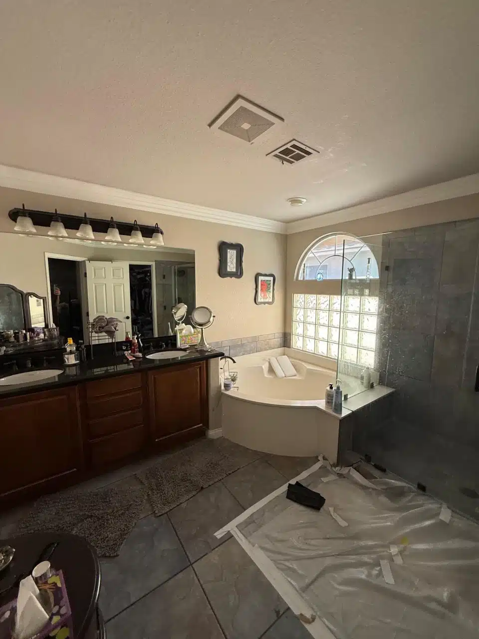 Master bathroom with the floor covered in protective sheeting before tile work